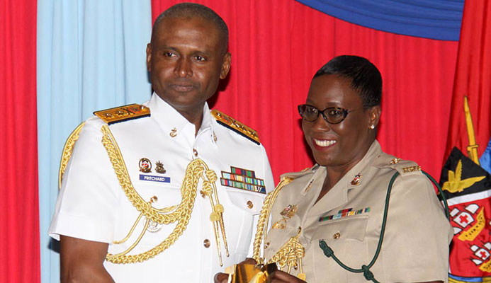 Chief of Defence Staff, Rear Admiral Hayden Pritchard, presents Major Leslie Ann McLeod-Mohammed, with an award for 30 years of Colour Service at the Launch of the Chief of Defence Staff's Military Women's Initiative, Hilton Hotel.