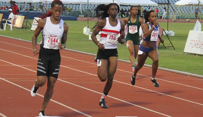Michelle Lee Ahye of club Rebirth, left, finished first in the 100m prelims at the NGC/Natonal Association of Athletics Administrations Open Championships at the Hasely Crawford Stadium yesterday. Placing second was Kamaria Durant of Simplex and third, Tahesia Harrington-Scott of British Virgin. PHOTO BY AYANNA KINSALE