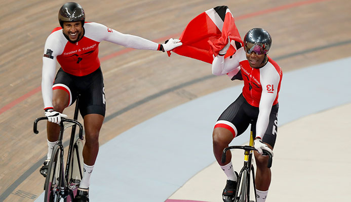 Trinidad and Tobago cycling team members, composed of Keron Bramble, Paul Nicholas and Njisane Phillip, celebrate winning the gold medal in the cycling track men's team sprint at the Pan American Games in Lima, Peru, Thursday, Aug. 1, 2019. (AP Photo/Fernando Llano)