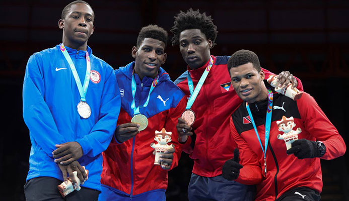 Silver medallist Keyshawn Davis of the United States, left, champion Andy Cruz of Cuba, centre, and bronze medallists Alston Ryan of Antingua and Barbuda, second right, and Michael Alexander of TT in the men's light welterweight boxing at the Pan American Games in Lima, Peru, earlier this month.