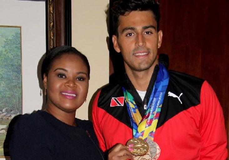 FLASHBACK: Shamfa Cudjoe, Minister of Sport and Community Development, left, and Dylan Carter at the VIP Lounge, Piarco International Airport in 2018. Minister Cudjoe holds one of the five medals earned by Carter at the 2018 CAC Games in Barranquilla, Colombia.