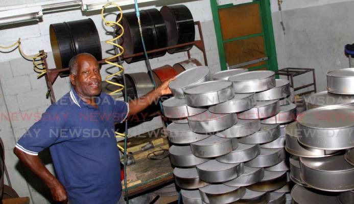 Panland president Michael Cooper highlights the miniature steelpans which the company manufacturers at its factory, Eastern Main Road, Laventille. - ROGER JACOB