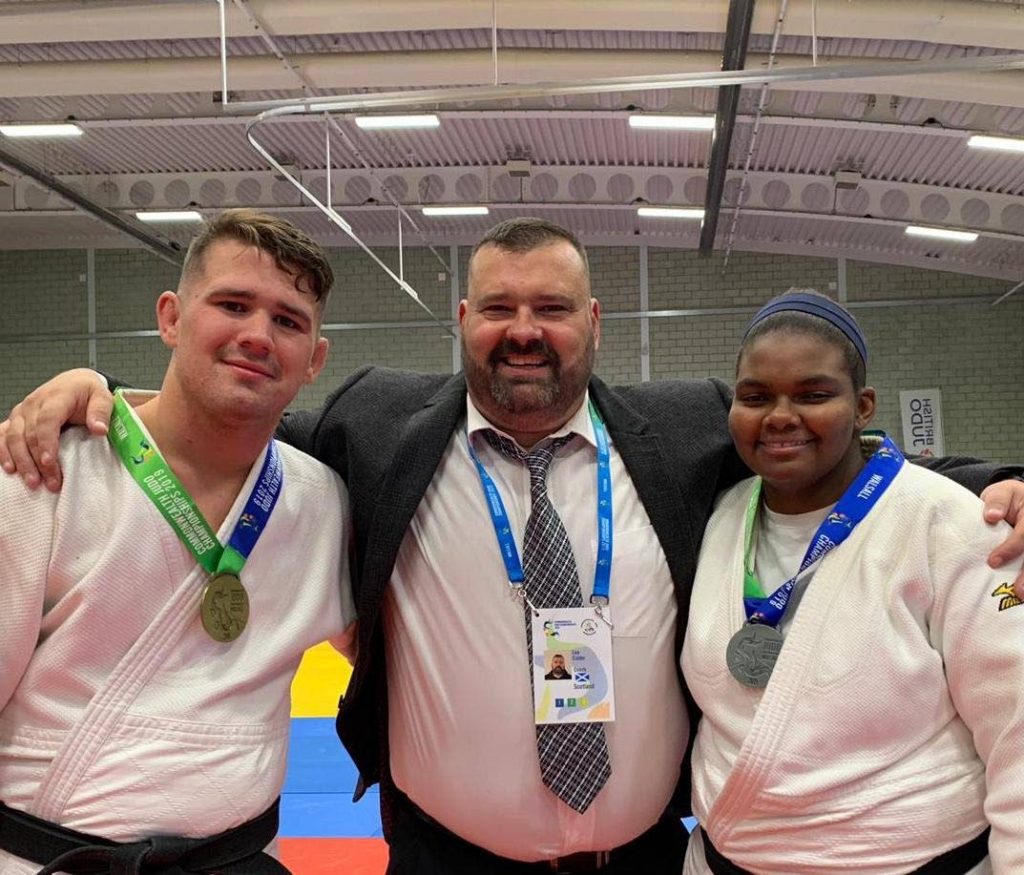TT's first female Olympic-bound judoka Gabriella Wood, right, with training partner Cailin Calder and coach Lee Calder, centre. -