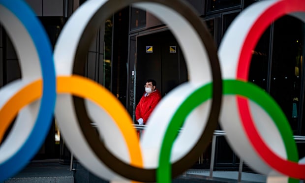 A member of staff outside the Olympic Museum in Tokyo. Photograph: Philip Fong/AFP/Getty Images