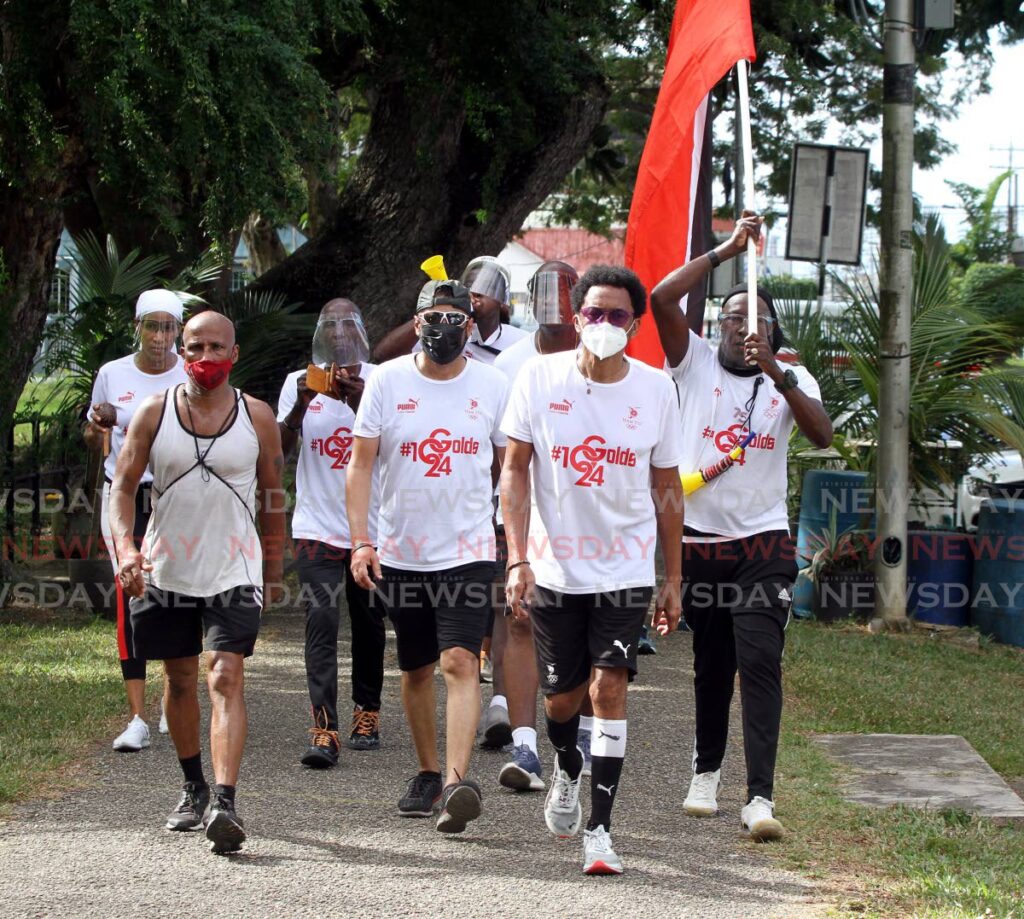 TT Olympic Committee president Brian Lewis (second from right) and his crew walk around the Queen's Park Savannah, Port of Spain at the conclusion of the TT International Marathon on Sunday. - Photo by Angelo Marcelle