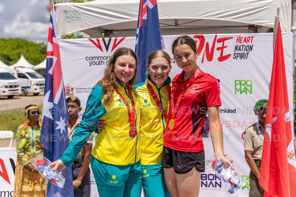 (l-R) Australia’s Keira Will (2nd place), gold medallist Lauren Emily Bates and Isle of Man’s Ruby Oakes (third place) celebrate after competing in the women’s cycling time trial, on Saturday, during the 2023 Commonwealth Youth Games, at the Brian Lara Cricket Academy, Tarouba. - Jeff K. Mayers (Image obtained at newsday.co.tt)