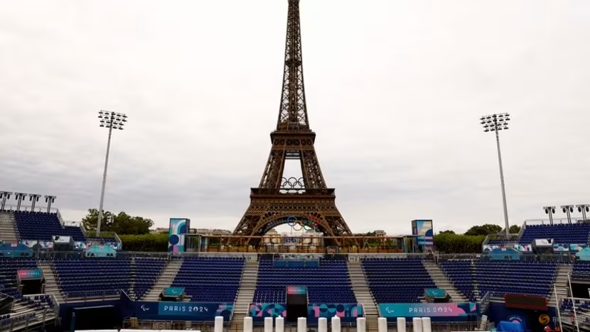 FILE PHOTO: Paris 2024 Paralympics - Paris, France - August 18, 2024 Workers work to convert the Eiffel Tower Stadium from the beach volleyball venue to the Paralympic blind football venue for the coming Paris 2024 Paralympic Games REUTERS/Abdul Saboor/File Photo (Image obtained at channelnewsasia.com)