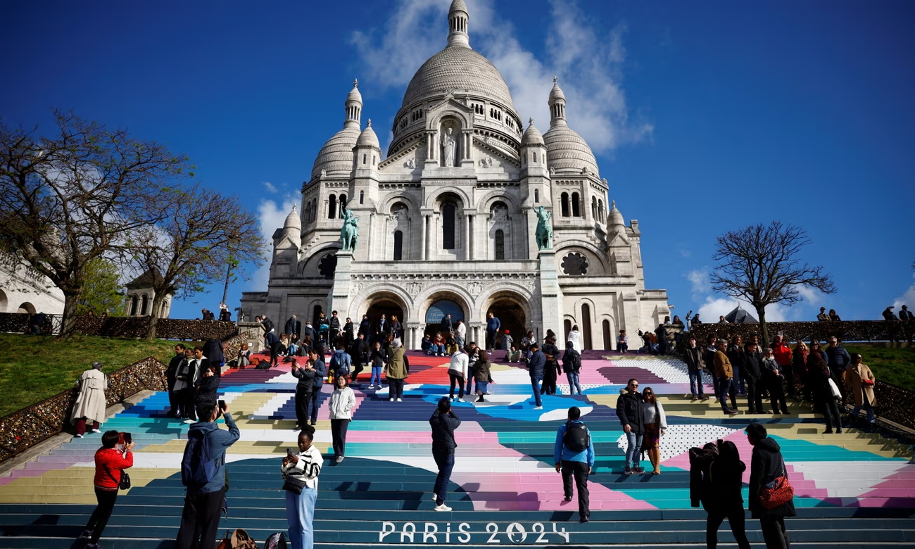 The Paris 2024 design decorates the steps of the Sacré-Coeur. Photograph: Sarah Meyssonnier/Reuters (Image obtained at theguardian.com)