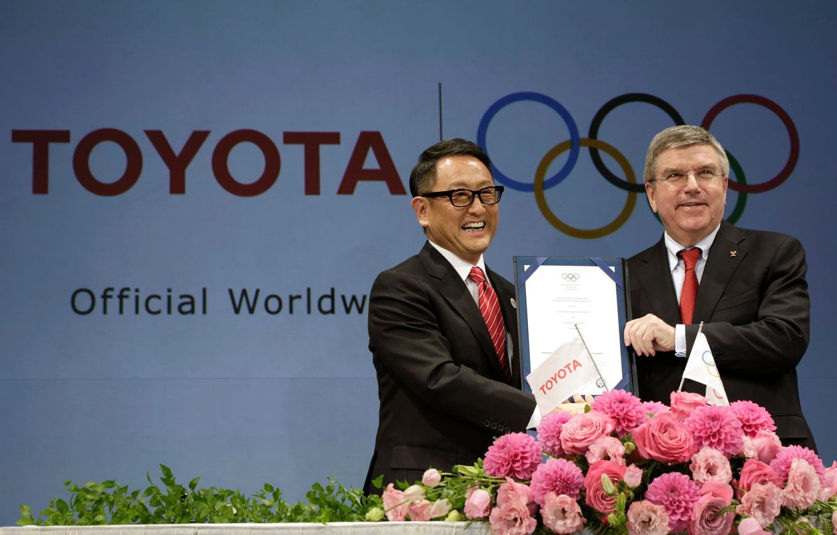 FILE - Toyota President and CEO Akio Toyoda, left, and IOC President Thomas Bach pose with a signed document during a press conference in Tokyo, on March 13, 2015 as Toyota signed on as a worldwide Olympic sponsor in a landmark deal, becoming the first car company to join the IOC's top-tier marketing program. Toyota will end its massive sponsorship deal with the International Olympic Committee after this year's Paris Olympics, according to reports in Japan. (AP Photo/Eugene Hoshiko, File) (Image obtained at mymotherlode.com)