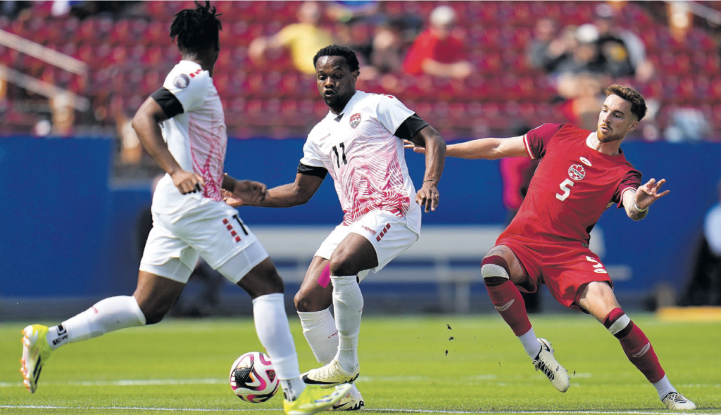 Trinidad And Tobago’s Levi Garcia, centre, makes a play with Canada’s Joel Waterman tracking closely in the first half of a Concacaf Nations League Play-In match, on Saturday. AP PHOTO (Image obtained at newsday.co.tt)