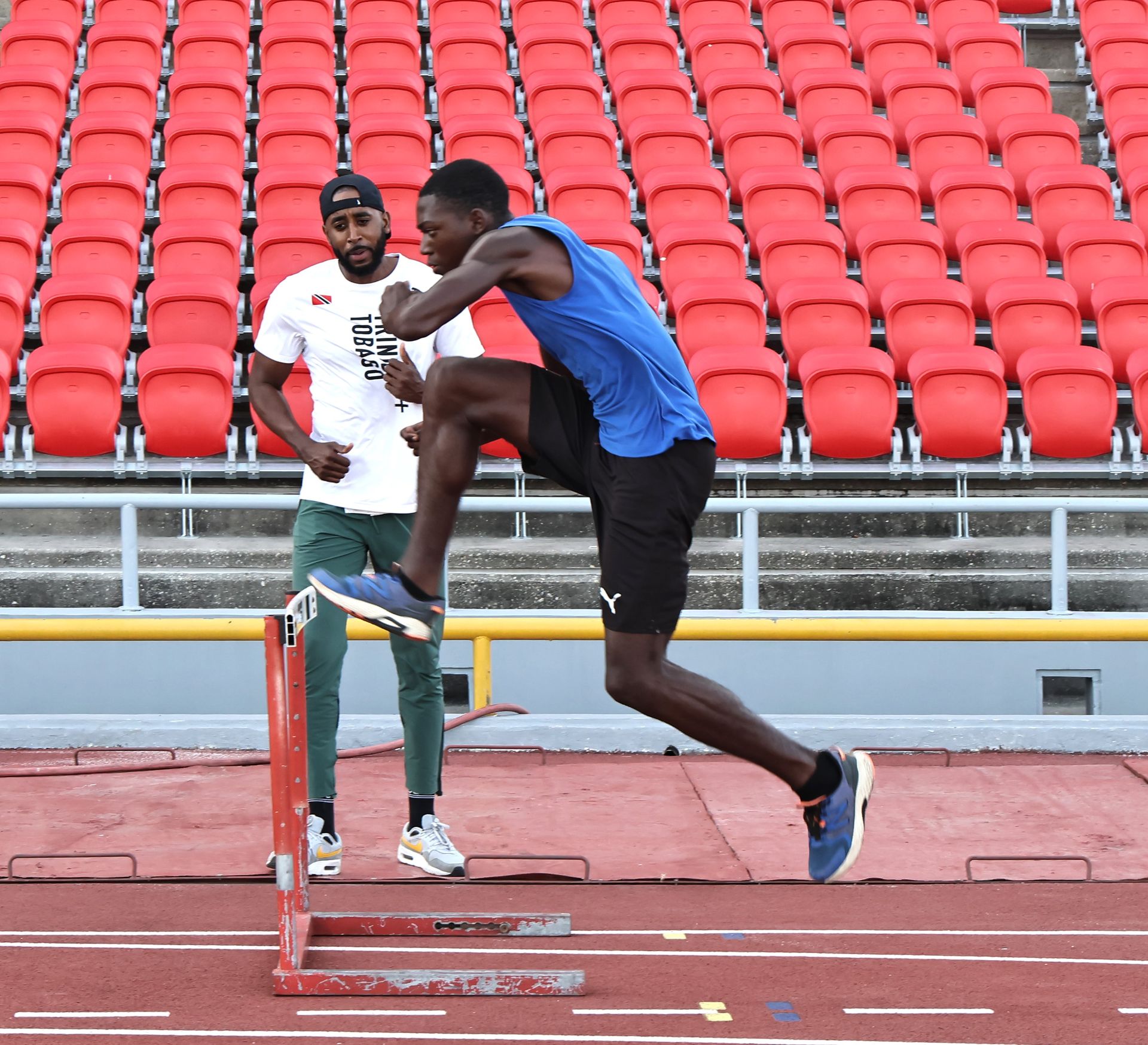 FILE: Former 400 metres hurdles champion Jehue Gordon, left, looks on as hurdler Tyrique Vincent goes through his routine during a training session for Carifta Athletes at the Hasley Crawford Stadium, Mucurapo, earlier this year.  ABRAHAM DIAZ (Image obtained at guardian.co.tt)