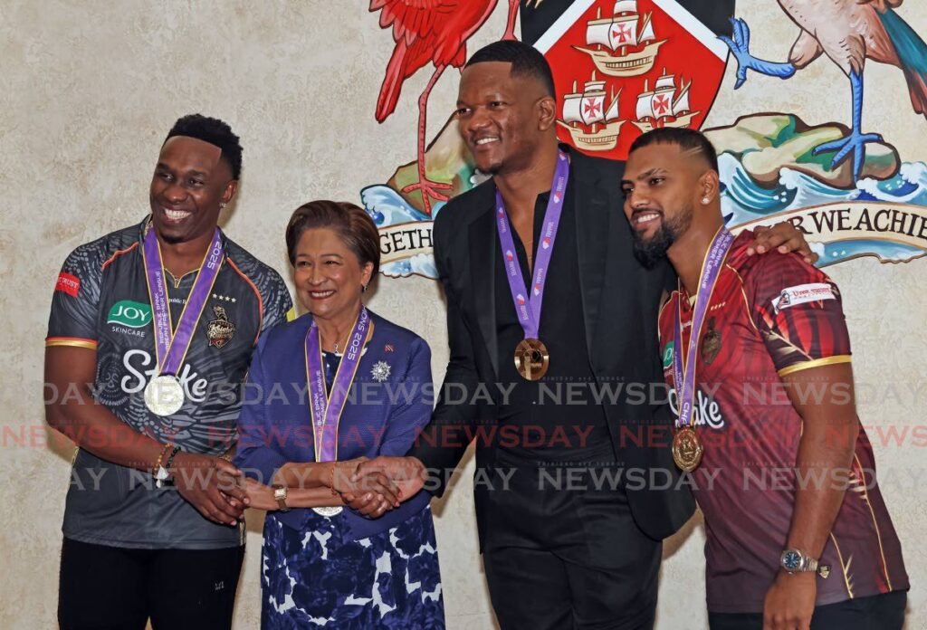 Prime Minister Kamla Persad-Bissessar congratulates Trinbago Knight Riders’ (TKR) coach Dwayne Bravo (L), javelin star and World Athletics Championship gold medallist Keshorn Walcott (2R) and TKR captain Nicholas Pooran, on September 23, at the Diplomatic Centre, St Ann’s. - Photo by Lincoln Holder (Image obtained at newsday.co.tt)