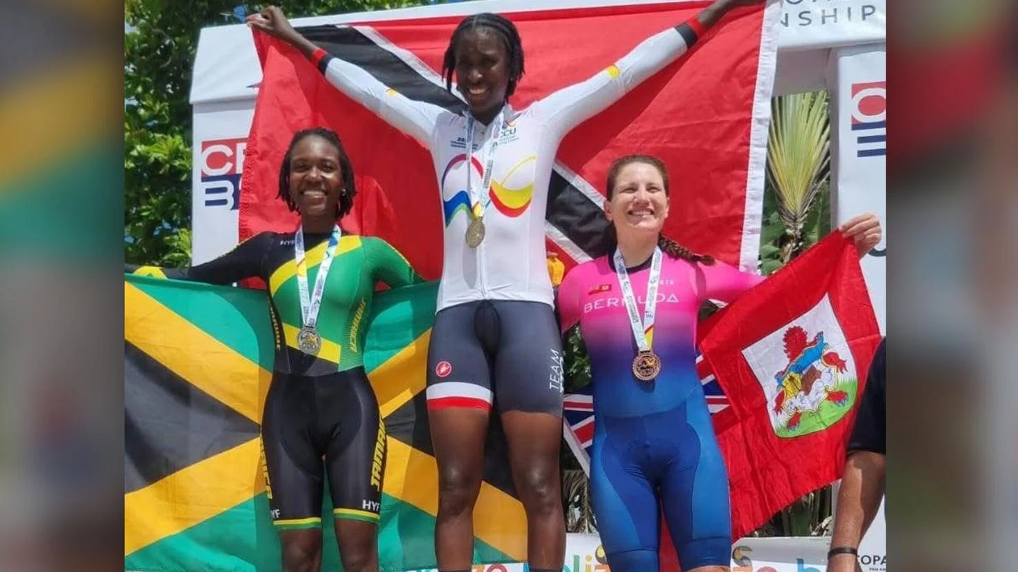 PODIUM POSSE: Teniel Campbell, centre, stands on top the podium, following her victory in the 2025 Caribbean Elite Road Cycling Championships Women’s Individual Time Trial, in Belize, yesterday. The Trinidad and Tobago cyclist finished ahead of Jamaican Llori Sharpe, left, and Bermuda’s Gabriella Arnold. —Photo courtesy TTCF (Image obtained at trinidadexpress.com)