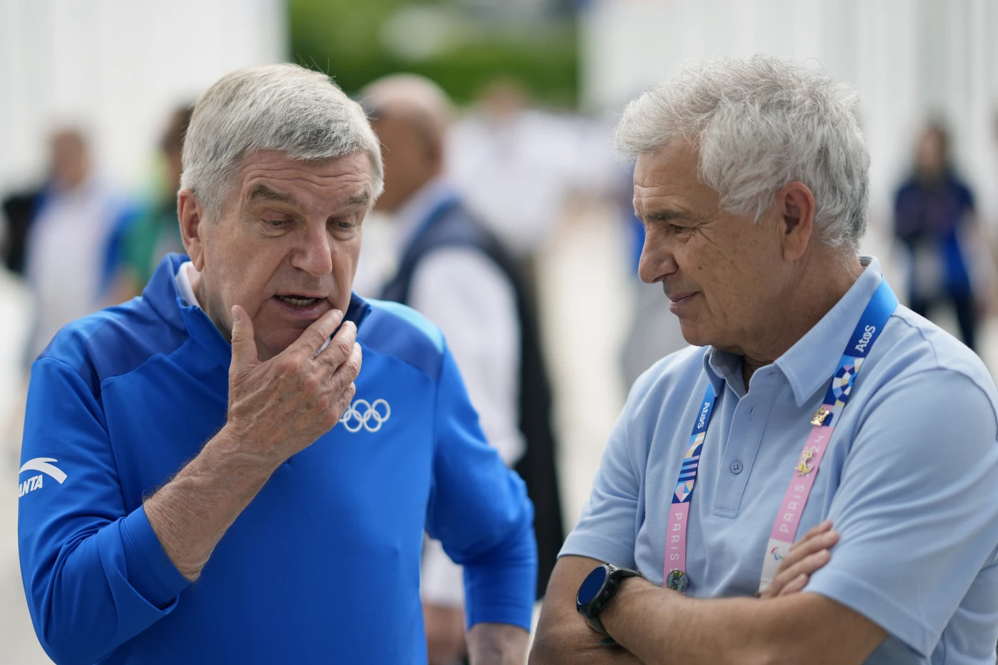 IOC President Thomas Bach, left, talks with former IOC President Juan Antonio Samaranch Jr. while touring the Olympic Village ahead of the 2024 Summer Olympics, Monday, July 22, 2024, in Paris, France. (AP Photo/David Goldman, Pool, File) (Image obtained at apnews.com)