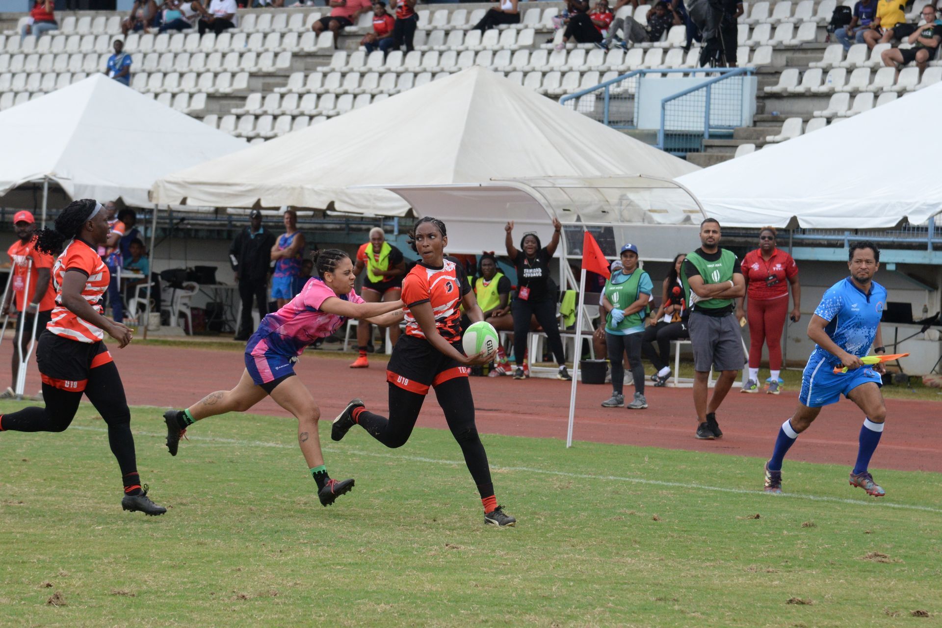 T&T’s Jade Husbands, right, makes a run pass the Bermuda defensive line, during the match between Bermuda and Trinidad and Tobago on Day Three Rugby Americas North Sevens 2025 competition at the Larry Gomes Stadium in Malabra Arima, yesterday.  ANISTO ALVES (Image obtained at guardian.co.tt)